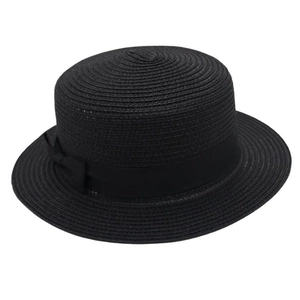 Close-up of black straw boater hat featuring a decorative satin ribbon bow detail