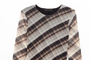 Macro detail of plaid mesh fabric showing precision stitching and neck label