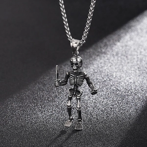 Macro view of vintage silver steel skull pendant holding a sword with textured details