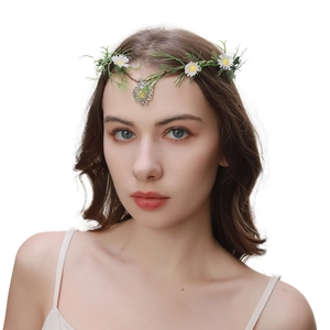 Close-up of green leaf headband with white daisies and a central emerald drop pendant