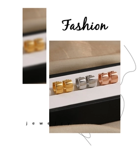 Close-up of brushed metal hoop earrings in gold, silver, and rose gold finishes