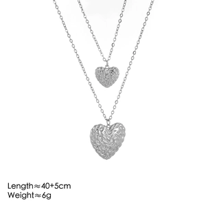 Detail shot of silver heart pendants with wrinkled texture and dimensions text