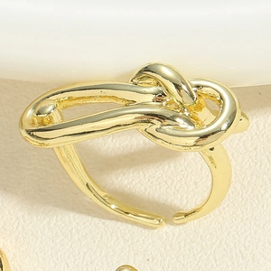 Detailed view of the 14K gold plated knot ring with an adjustable open design