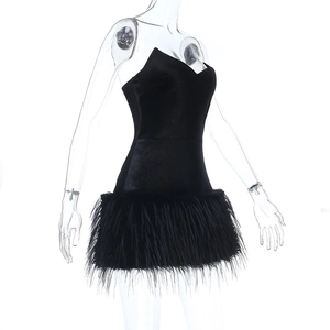 Detail of black strapless mini dress featuring a plush faux feather trimmed hemline