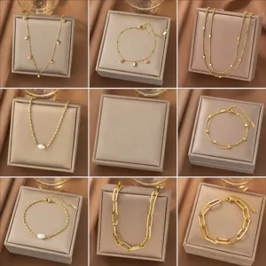 Detailed grid of gold necklaces and bracelets featuring pearls and pink zircon accents