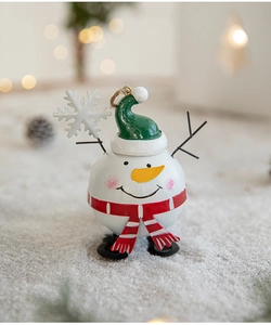 Detailed view of a cute snowman figurine with a green hat and red scarf for Christmas decor