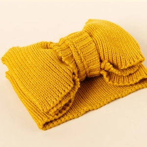 Detailed knit texture of a yellow double-layer elastic bow headband for infants