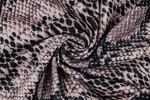Macro shot of snakeskin print textile fabric showing detailed texture and soft folds