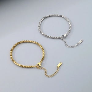 Detail of 18K gold and silver wheat chain bracelets with lobster clasp and K18 tag
