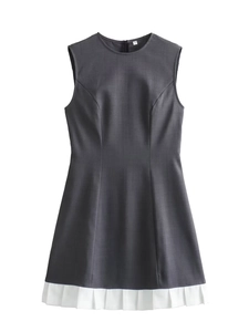 Detail of grey sleeveless dress showing the white pleated hem and high waist stitching