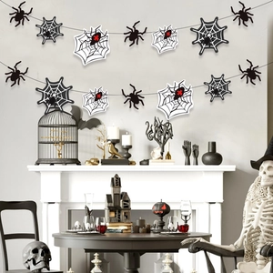 Halloween spider and web banner set hanging above a decorated fireplace mantel