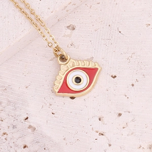 Close-up of golden stainless steel chain with a red and white evil eye heart pendant