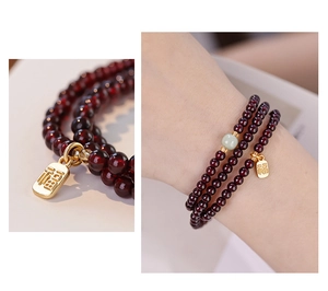 Macro detail of garnet beads with gold Fu pendant and model wearing the wrap bracelet