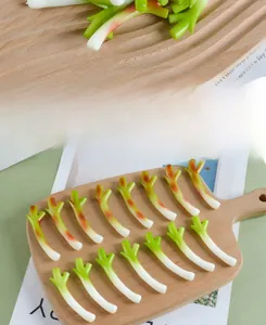 Detailed view of realistic artificial green onion charms on a wooden platter