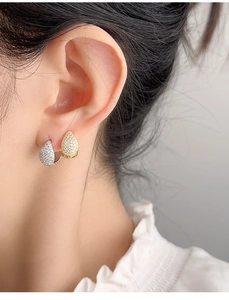 Detailed close-up of water drop hoop earrings with pave-set shimmering crystals