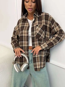 Close-up of brown and beige plaid shirt featuring soft texture and single pocket detail