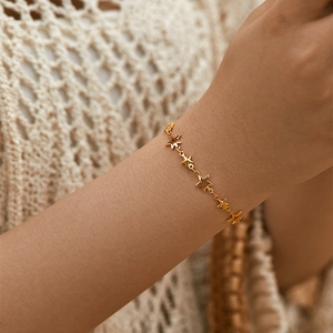 Star-shaped 18K gold plated hollow bracelet elegantly worn on a female wrist
