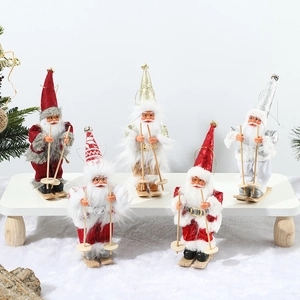 Set of five plush Santa Claus figurines on wooden skis for Christmas tree decoration