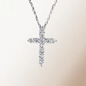 Macro detail of cross pendant featuring 11 sparkling moissanite stones in silver setting