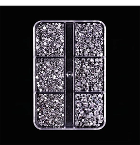 Macro view of mineral silver flatback glass rhinestones in a six-grid organizer box