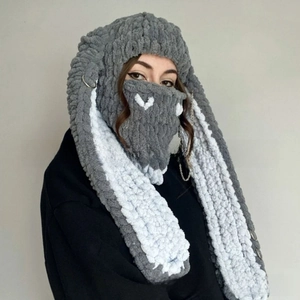 Detail of grey handmade crochet balaclava with long rabbit ears and metal chain decor