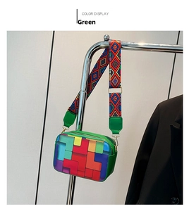 Detail of color-block crossbody bag with geometric pattern and wide ethnic woven strap