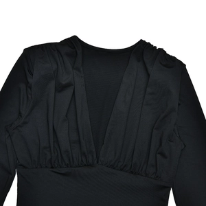 Detail view of the deep V-neckline and intricate pleated design on black long sleeve bodysuit