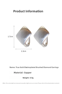 Macro shot of geometric square hoop earrings with gold plating and brushed metal finish