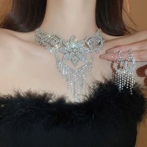 Detailed view of silver flower tassel necklace set with sparkling crystals for elegant evening wear