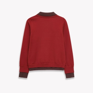 Pull polo en maille rouge à manches longues avec col et poignets marron contrastés