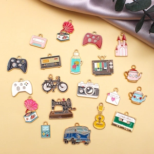 Detailed flat lay of 19 vintage alloy enamel charms including retro cameras and bicycles