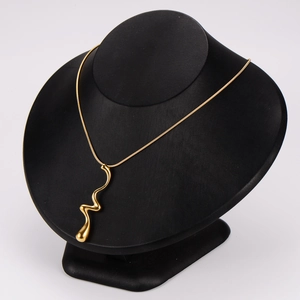 Elegant gold wave pendant necklace displayed on a professional black jewelry mannequin stand