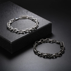 Minimalist stainless steel chain bracelet with spring charm in silver and black finish