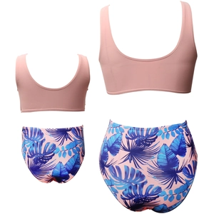 Flat lay of pink tankini sets with tropical leaf prints for mother and daughter matching