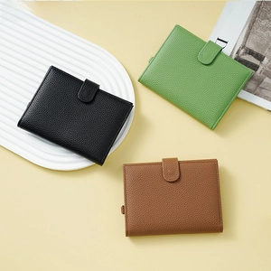 Detailed view of pebbled leather texture on slim passport wallets in three colors