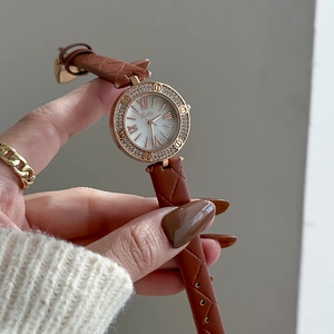 Luxury rose gold women's watch with brown leather strap and diamond bezel and Roman dial