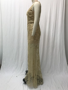 Detailed view of shimmering gold sequins on a sleeveless floor-length evening gown