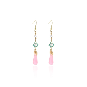 Detail of elegant Chinese style drop earrings with green enamel and pink crystal teardrops