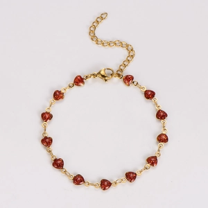 Detail of gold chain bracelet with thirteen red glitter heart charms and lobster clasp