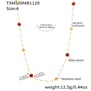 Long beaded necklace with red glass stones and clover charms in gold-toned stainless steel