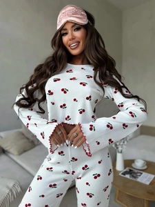 Detail of waffle knit fabric pajama set featuring red cherry print and lettuce trim finish