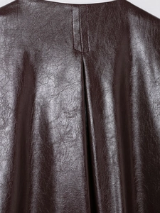 Macro view showing the pleated back detail and stitching on dark brown faux leather jacket