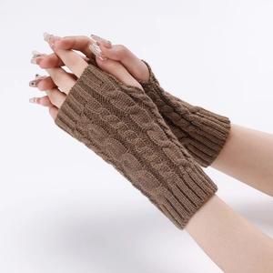 Close-up of the cable knit texture on brown fingerless gloves and warm arm sleeves