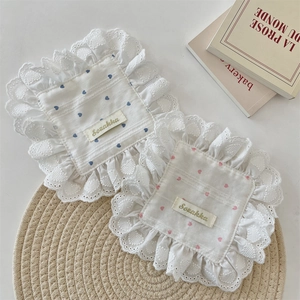 Detailed close-up of lace-edged coasters with blue and pink heart patterns on white fabric