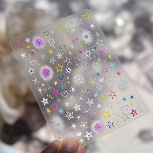 Macro detail of laser holographic nail stickers with colorful star and heart patterns
