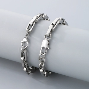 Polished titanium steel thick box chain bracelet for men with lobster clasp on grey stand