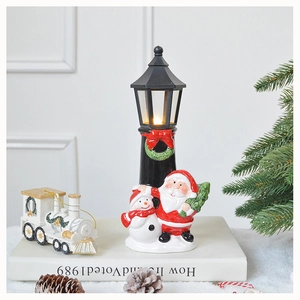 Detail of Christmas street lamp ornament with Santa and Snowman figures on white books