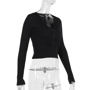 Detail view of black V-neck knitted cardigan showing ribbed texture and black buttons