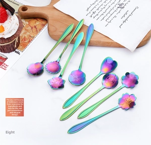 Detailed macro of eight colorful floral stainless steel spoons for coffee and dessert