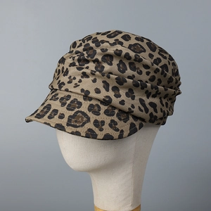 Fashionable leopard print military cap with ruched crown displayed on a mannequin head